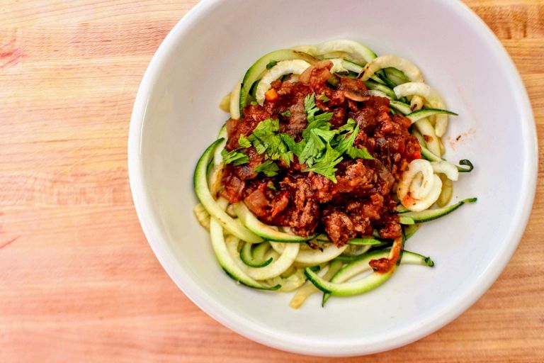 Product Review: Briefton's 5 Blade Spiralizer - Zucchini noodles topped with rich tomato sauce and fresh herbs, ready to eat.