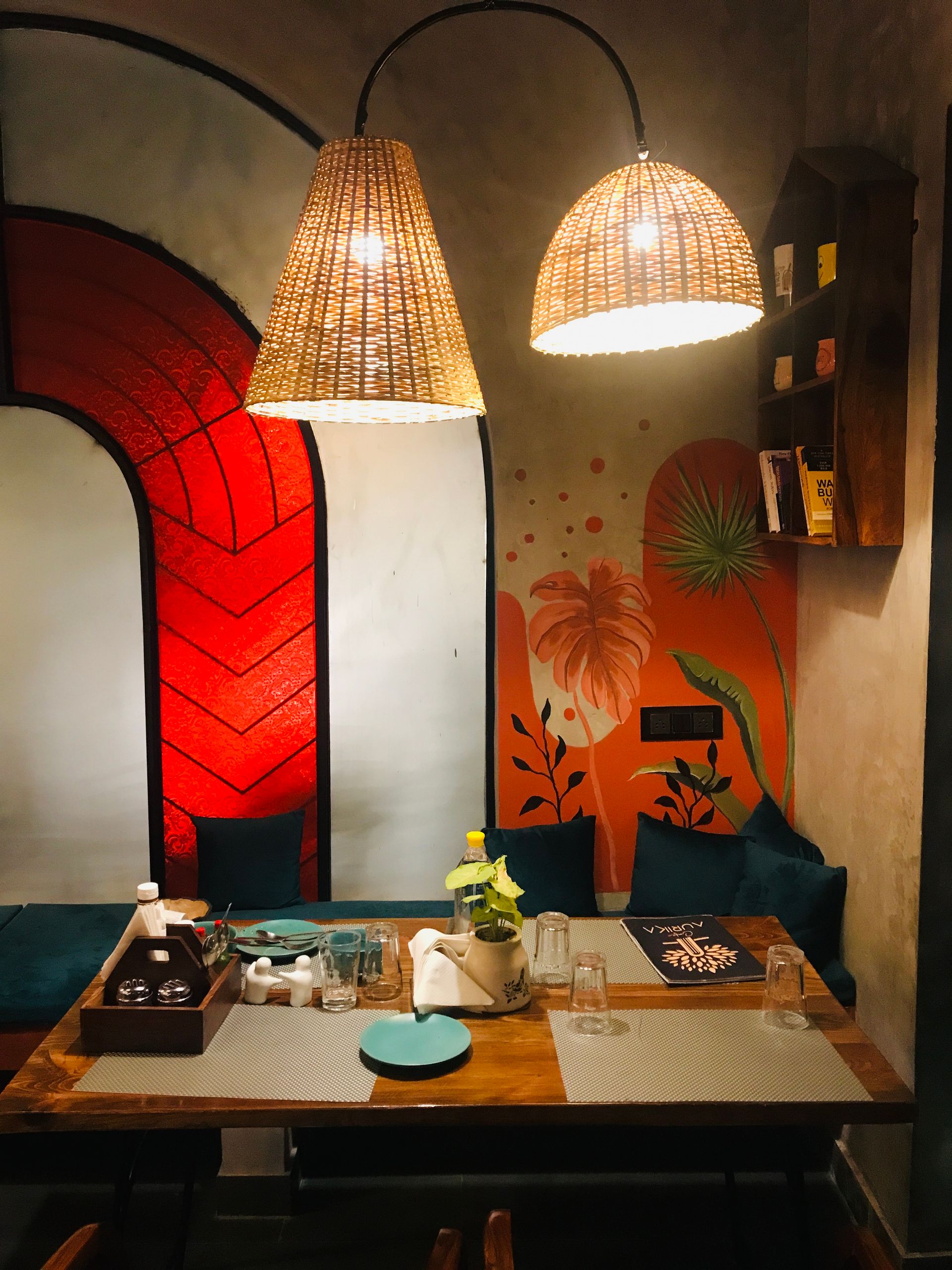 Restaurant Light - Warm and inviting restaurant setting with unique lighting and colorful mural.