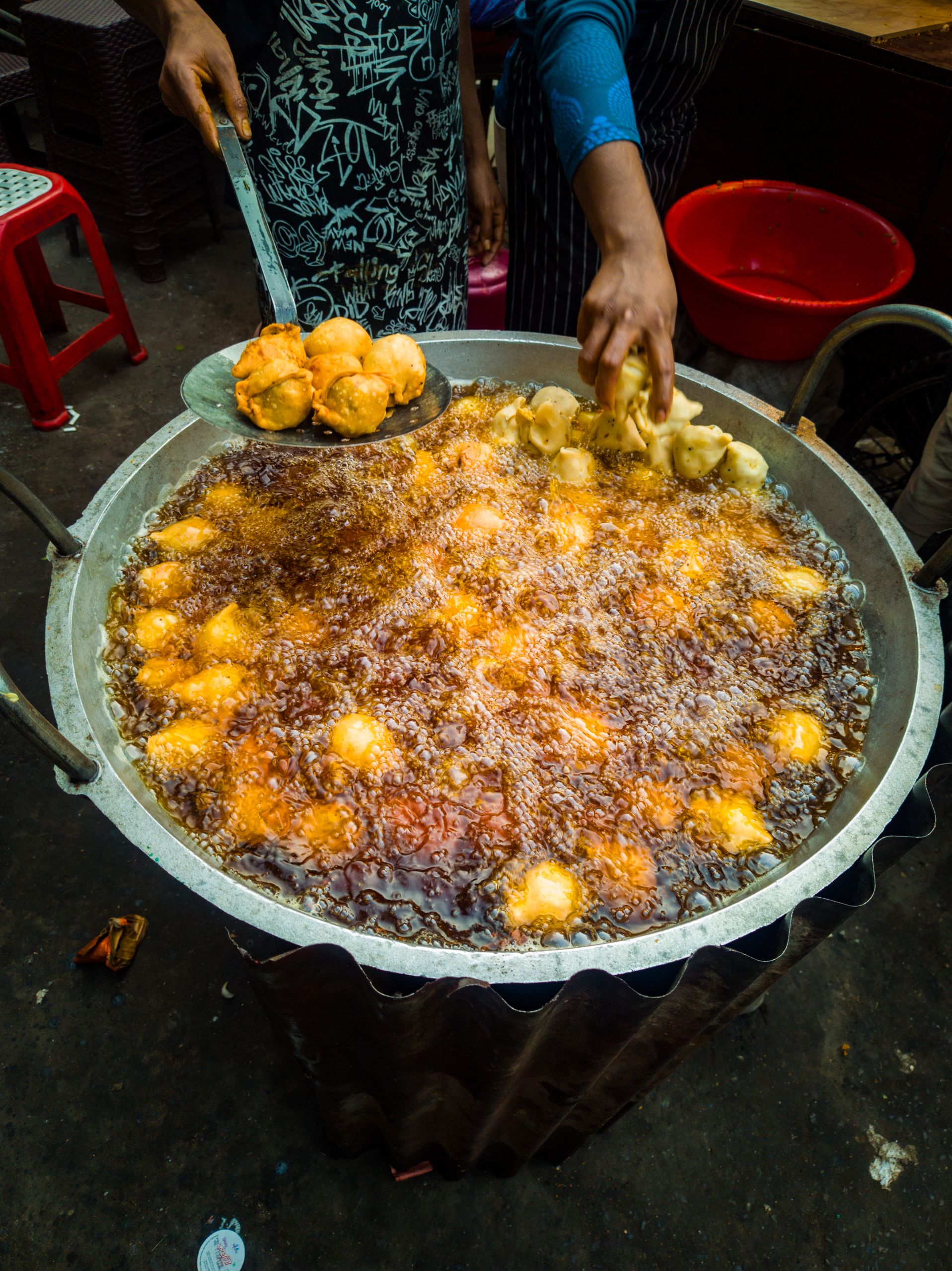 Roadside Food - Singara frying in hot oil at a vibrant street market in Dhaka, Bangladesh.