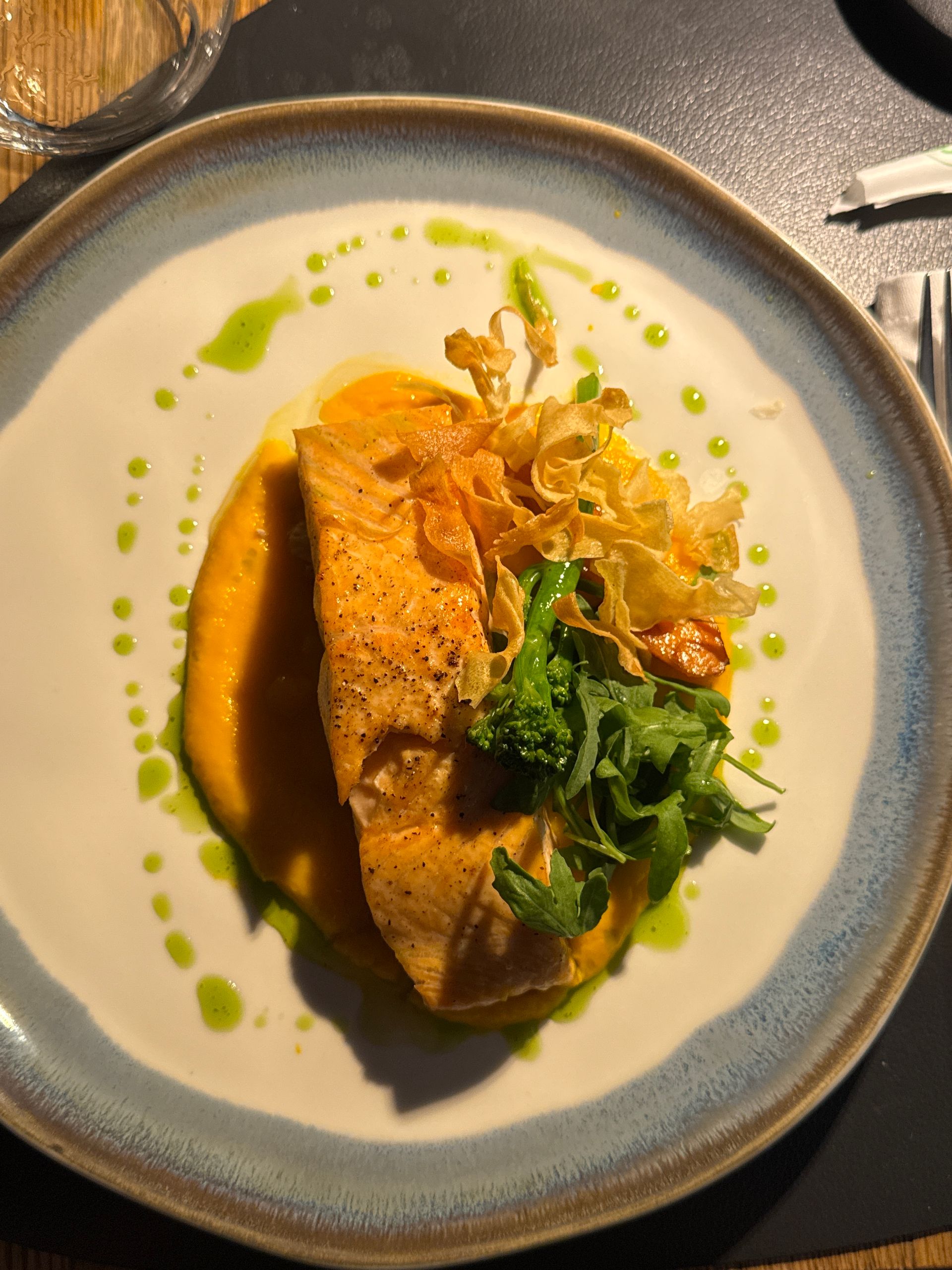 The Best Meals Make Me Ask Better Questions - Elegant salmon fillet with vegetables and sauce on a white plate.