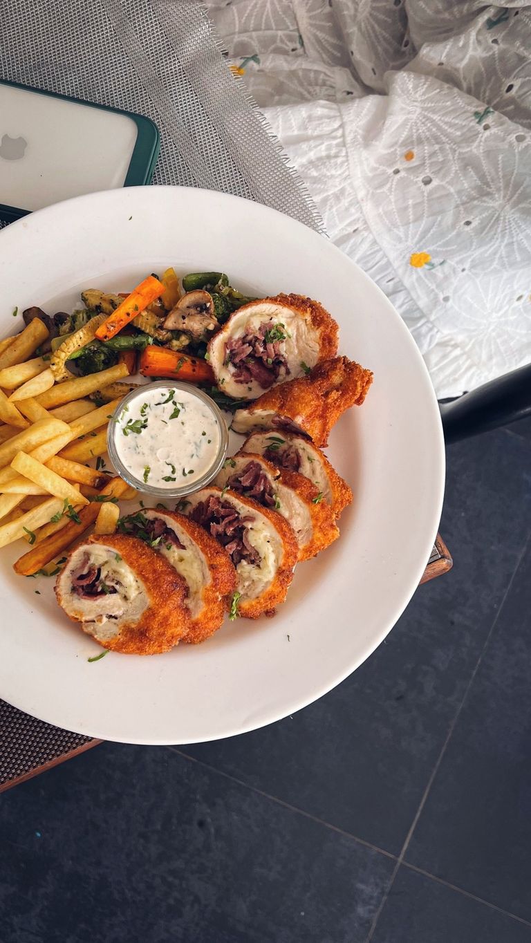 The Dish That Makes the Whole Room Quiet - Delicious crispy chicken rolls served with fries and grilled vegetables on a plate.