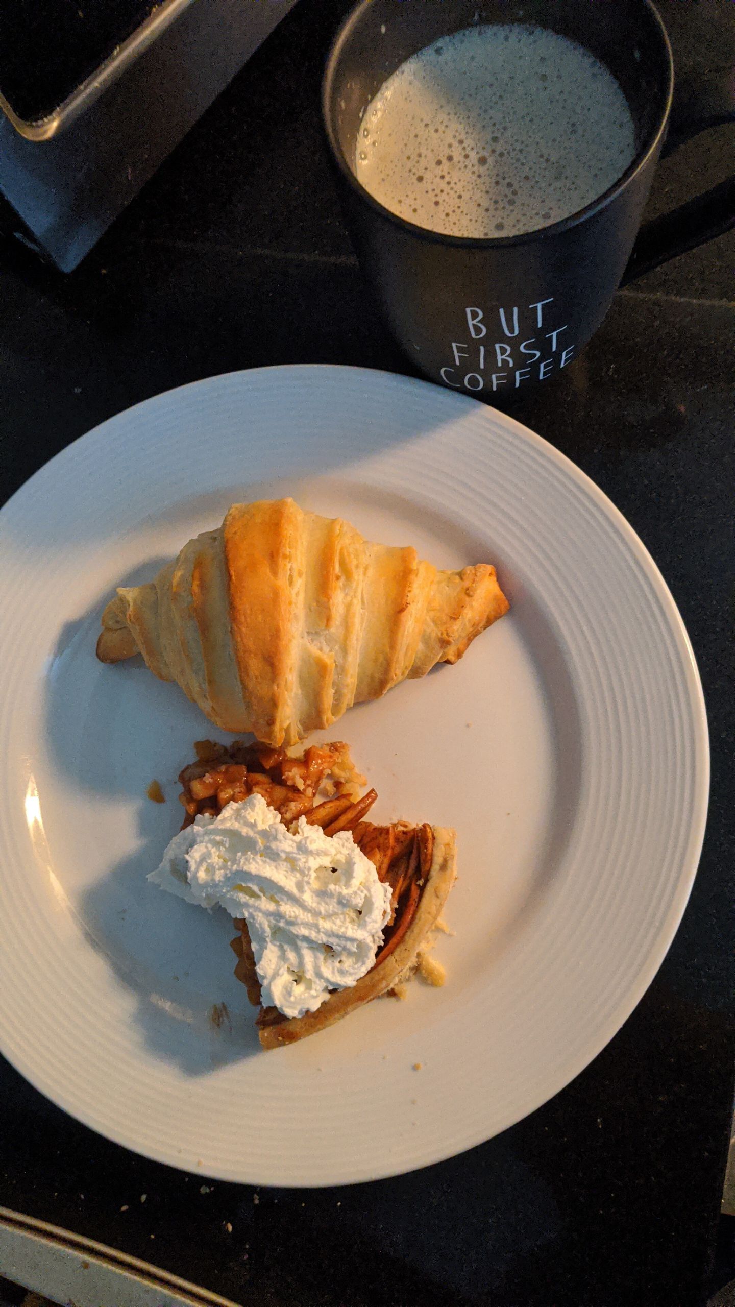 The First Meal After the Journey Brings Me Home - A savory breakfast featuring a croissant, pie with whipped cream, and coffee in a stylish mug.