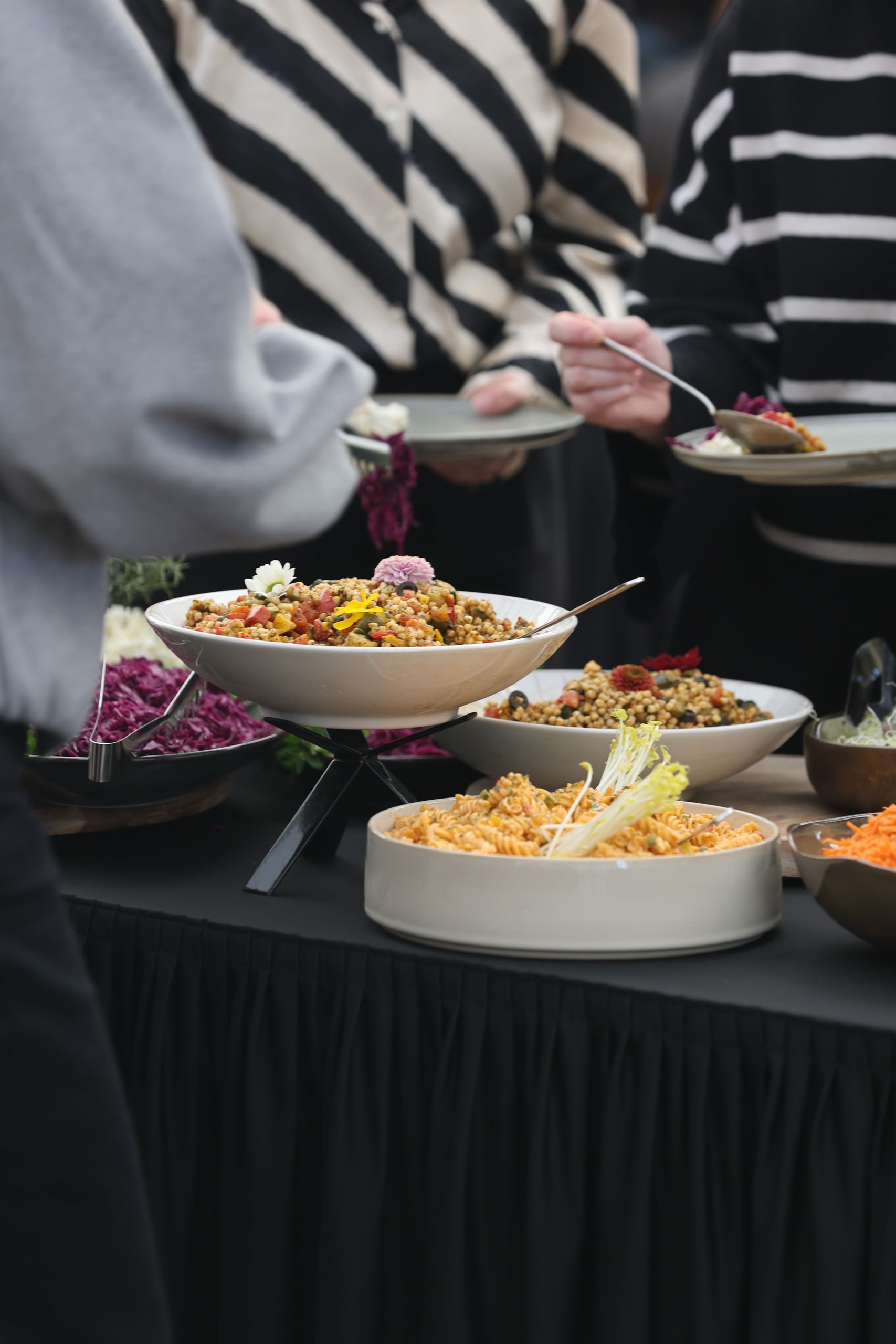 The Good Pot - A diverse array of colorful dishes on a buffet table at a gathering, featuring salads and grains.