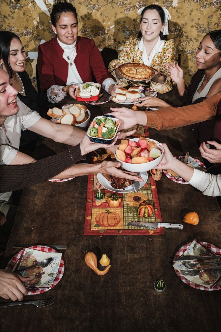 The Kind of Gratitude That Includes Everybody - Diverse group celebrating Thanksgiving with a shared festive meal.