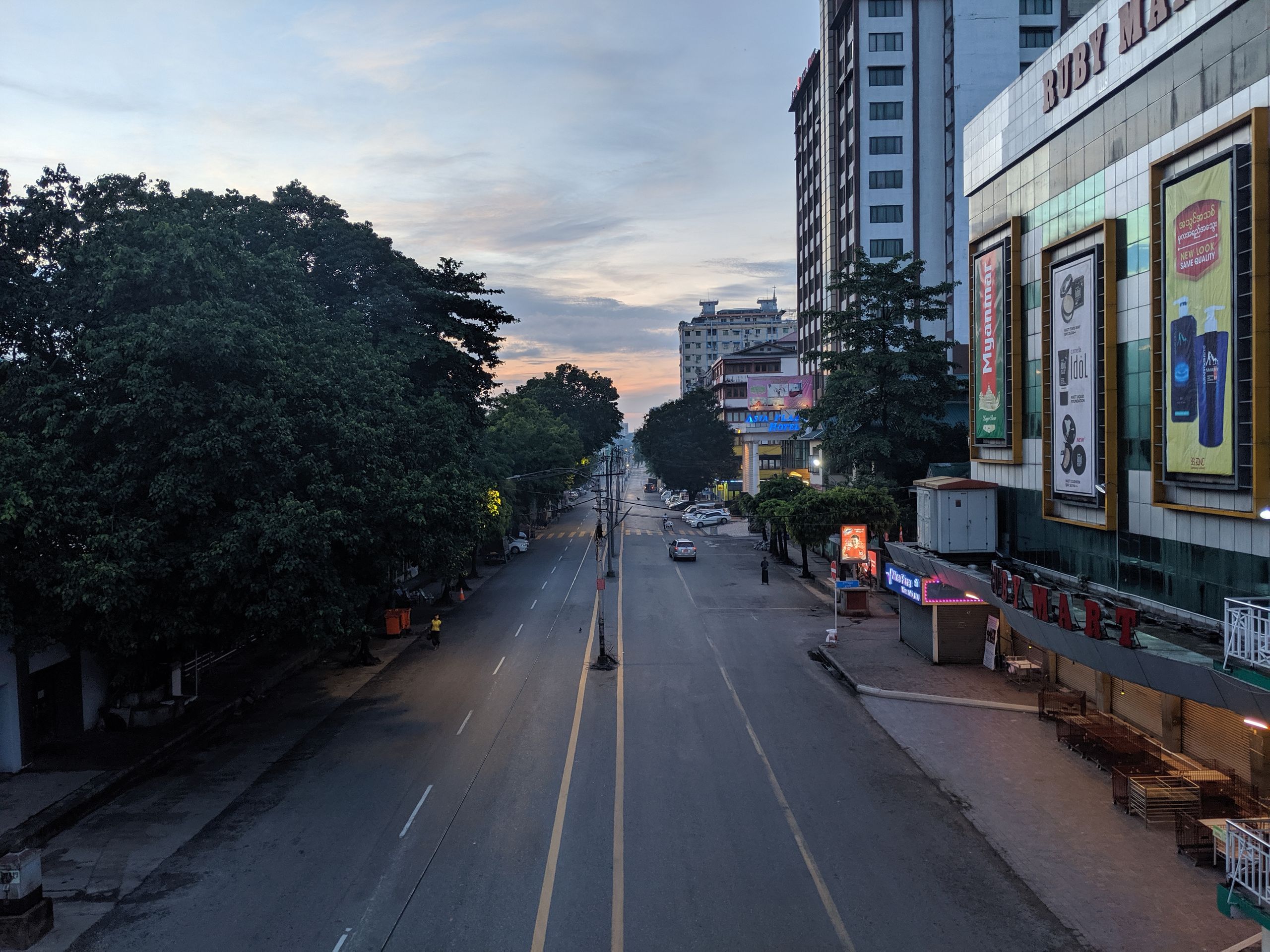 What a City Reveals Before the Day Gets Loud - Serene city street in Yangon, Myanmar at dawn with empty roads and buildings.