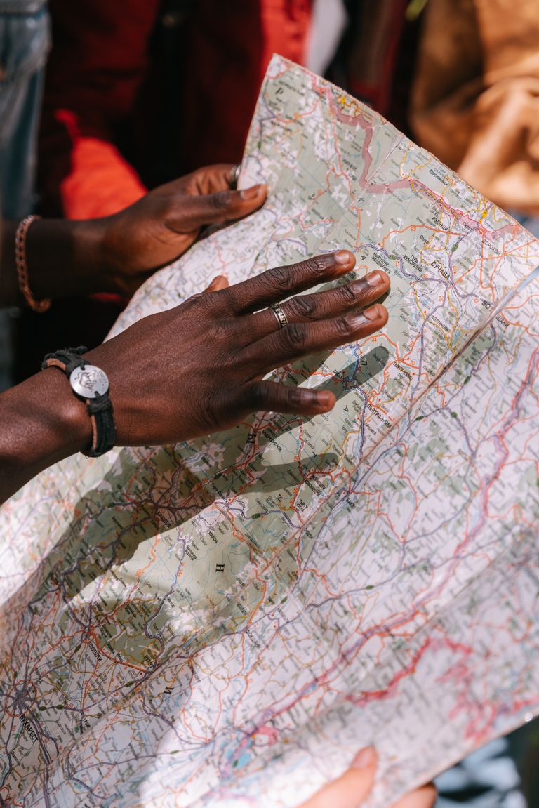 What a Good Map Cannot Tell Me - A close-up of a man's hands examining a map, perfect for travel and adventure themes.