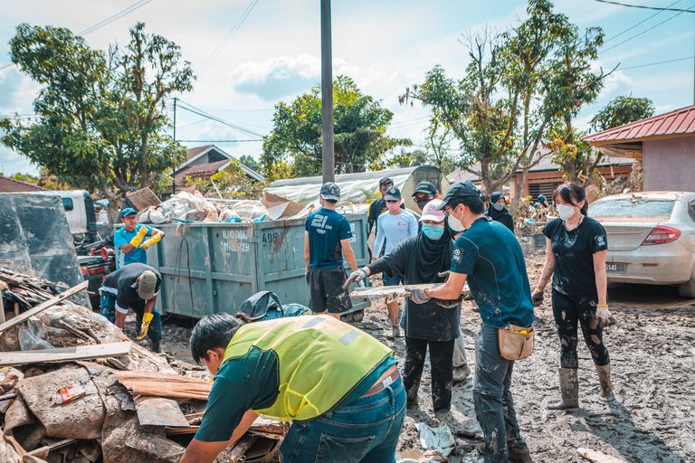 What Community Resilience Looks Like in Real Life - Volunteers work together to clean up debris after a natural disaster, showcasing community effort and teamwork.