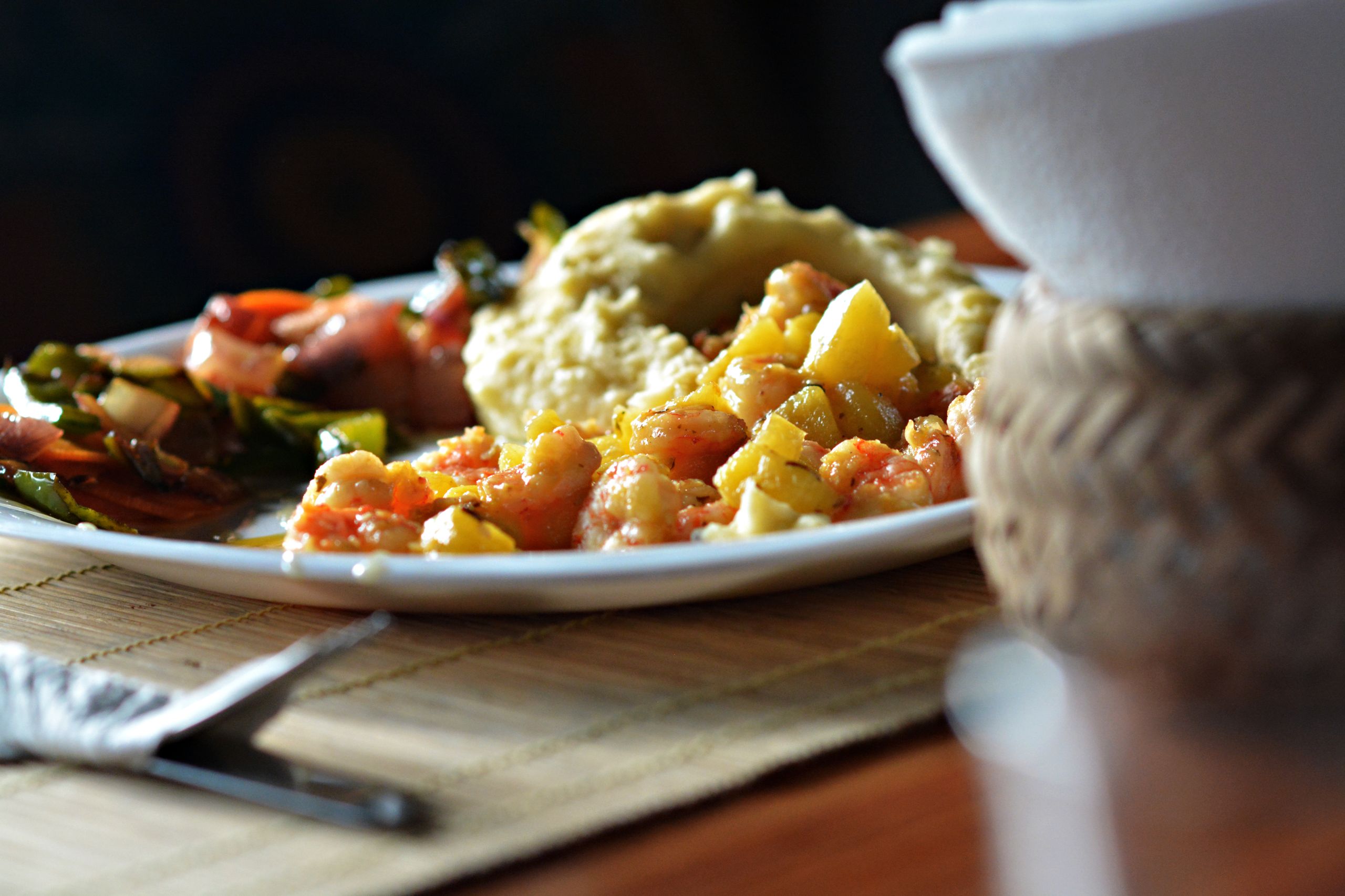 What Slow-Cooked Food Teaches Me About Time - Savor this vibrant Ecuadorian seafood dish with potatoes and vegetables served on a wooden table.