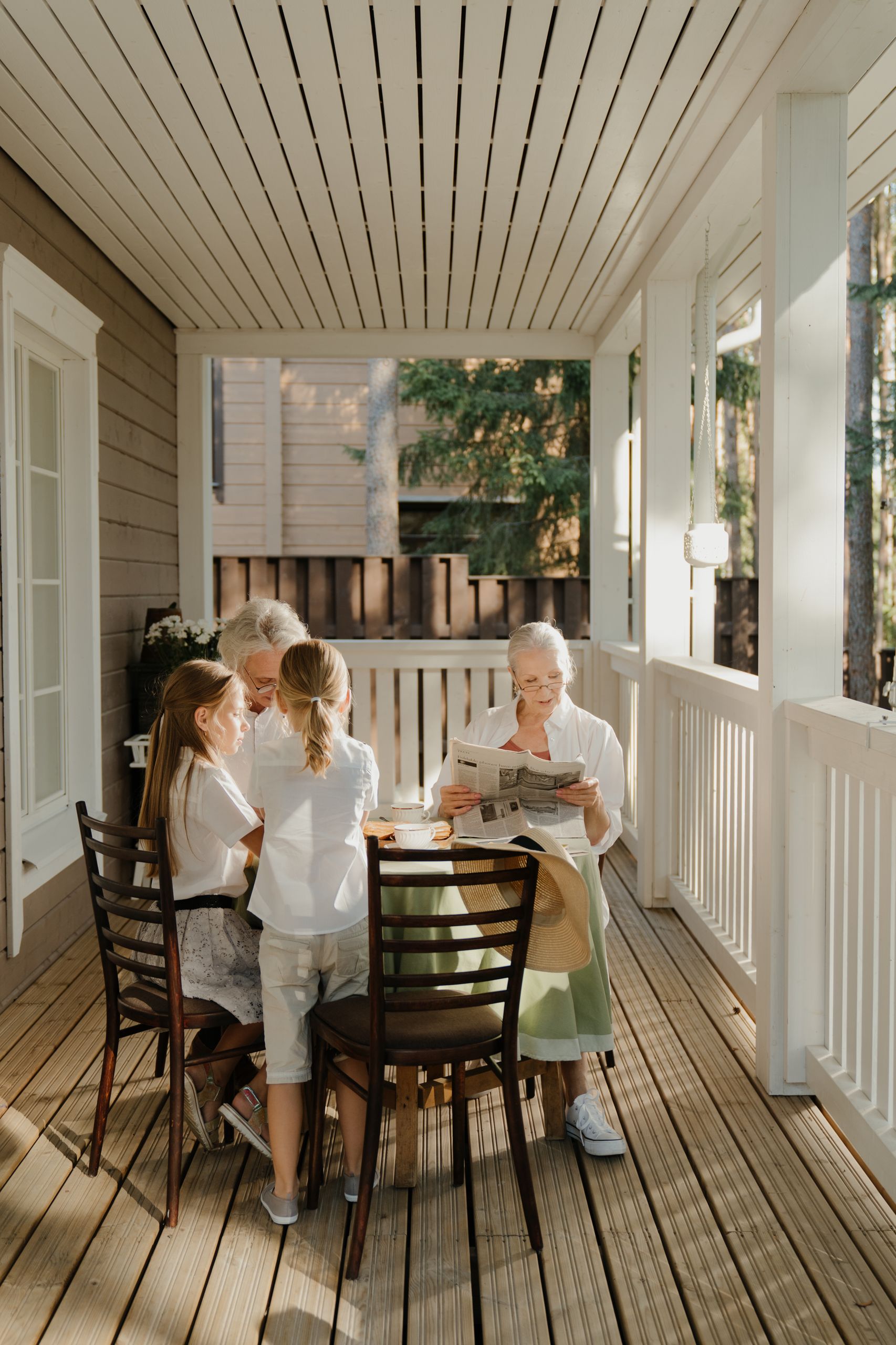 What the Porch Knows About Community - Grandparents enjoying family time with grandchildren on a sunny veranda.