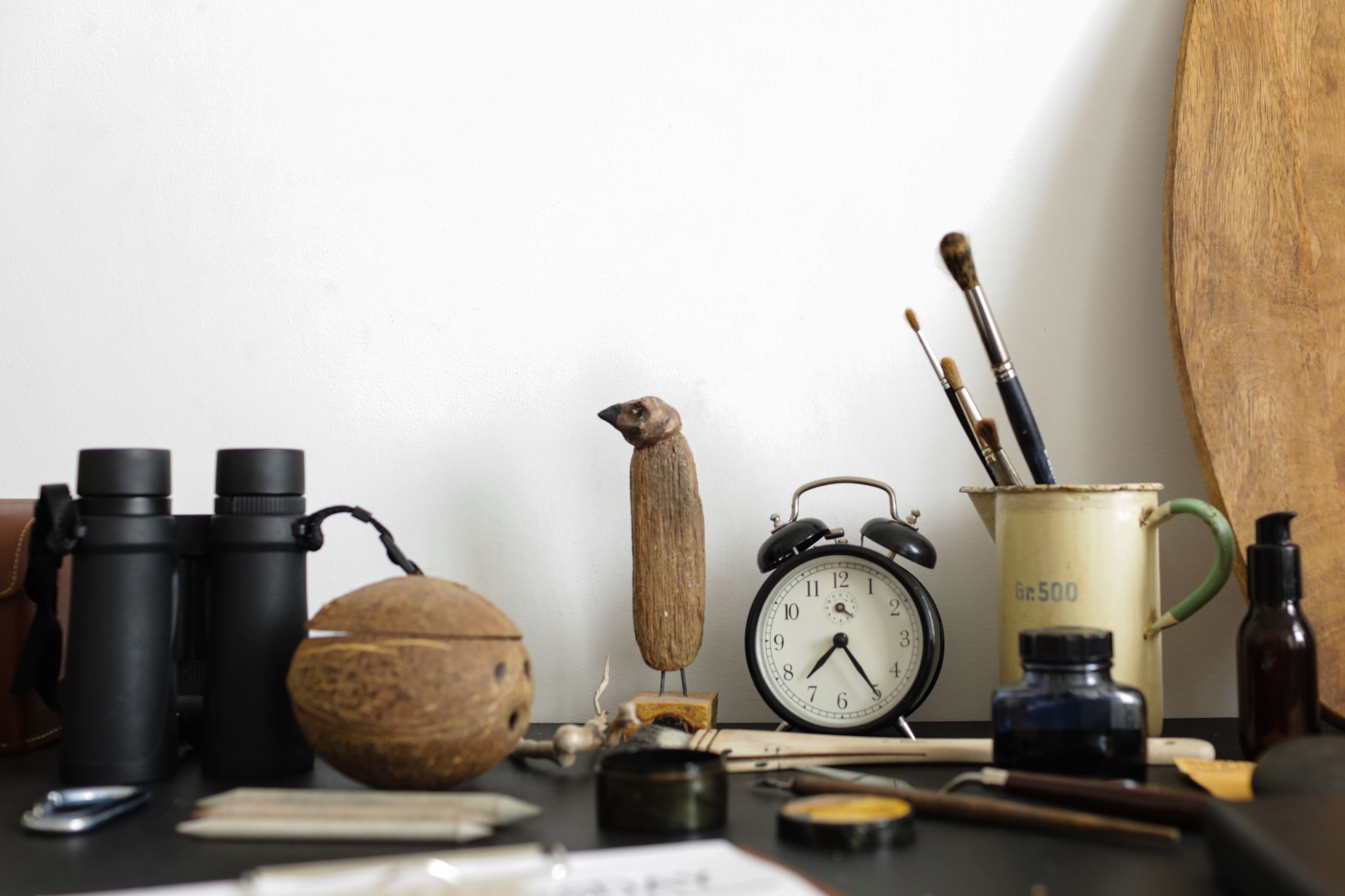 Why I Keep Writing About Ordinary Life - A creative arrangement of art supplies and objects on a desk with a vintage vibe.