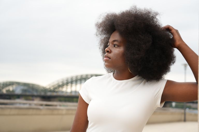 Why Your Hair Doesn't Define You - Captivating portrait of a woman with afro hair in Köln, showcasing elegance and style.