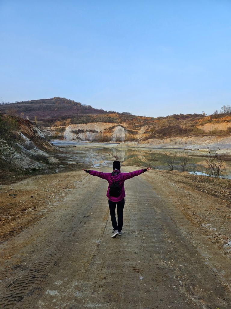 Year-End Walks Help Me Hear Myself - Lone hiker in a pink jacket enjoying a serene walk at a scenic quarry.